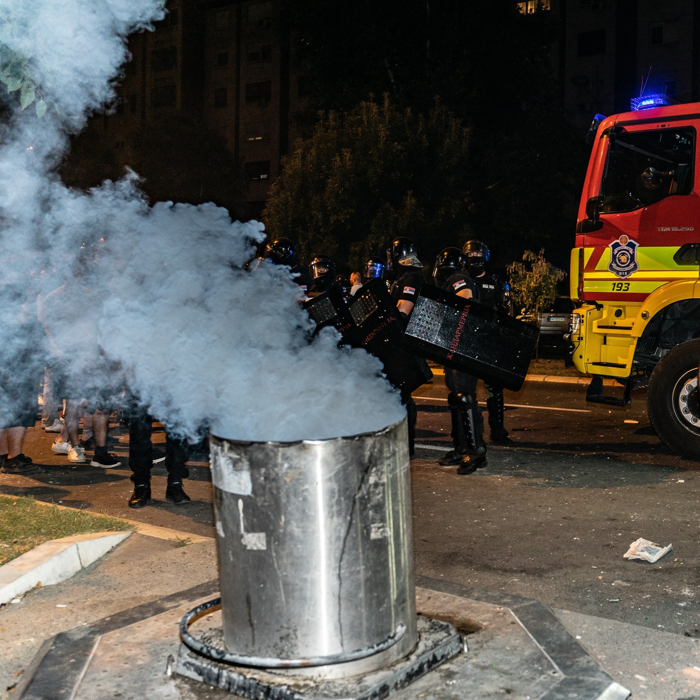 Police by underground bin fire